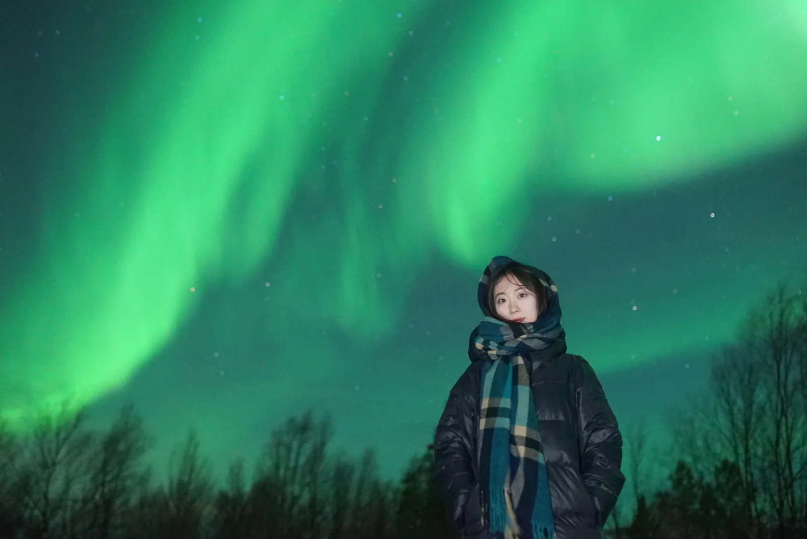 A guest portrait beneath the aurora